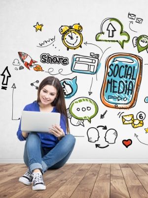 Woman with computer surrounded by social media
