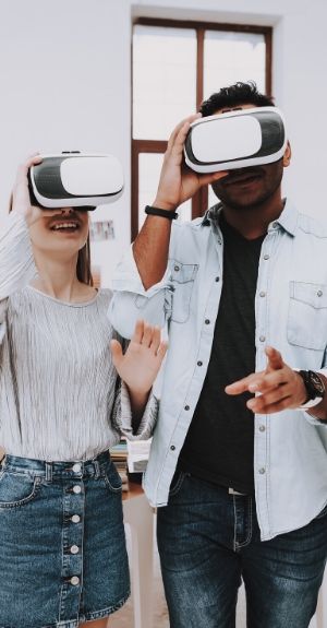 couple wearing vr headset happily