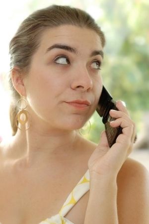 woman rolling eyes on phone